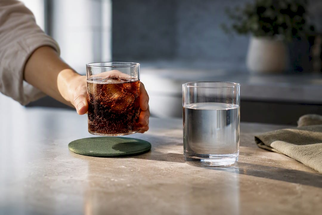Fizzy drink beside still water