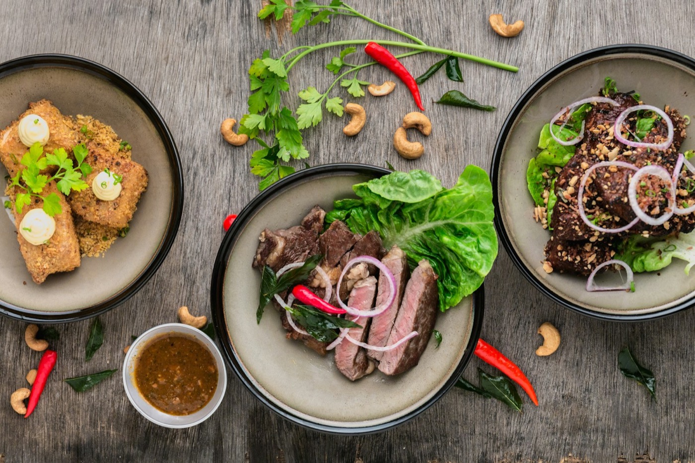 Colourful plated healthy meals on a dark surface