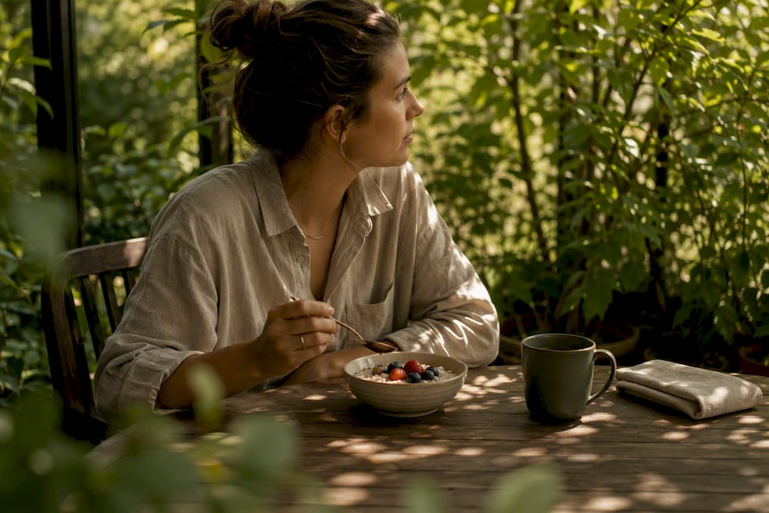 Person practicing mindful eating at breakfast table